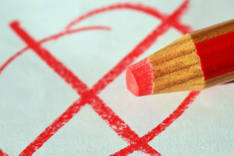 red pencil with a x